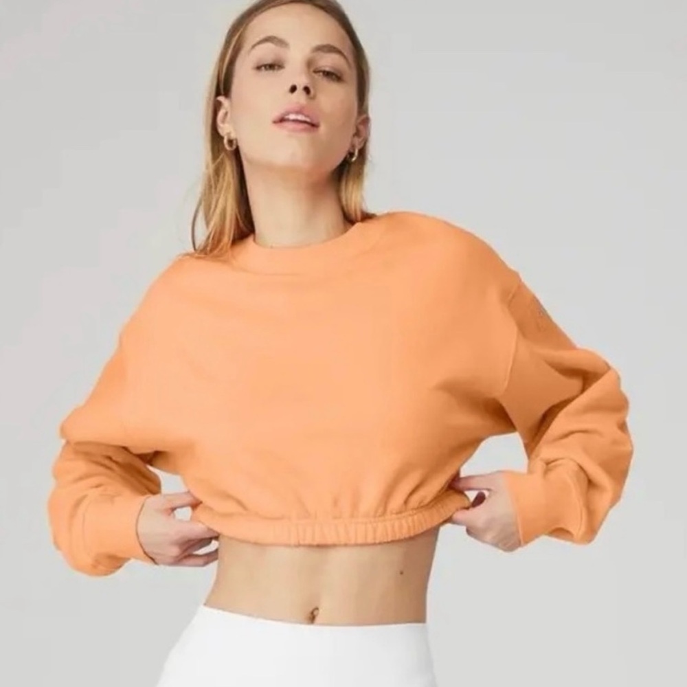 Alo yoga devotion crew neck pullover in cantaloupe